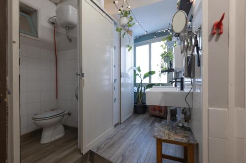 a bathroom with a toilet and a sink at Ostello degli Elefanti in Catania