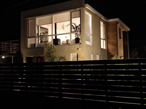 a house with windows and potted plants on it at La Juanita Jose Ignacio in José Ignacio