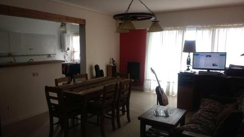 a living room with a dining room table and a kitchen at Habitación privada en Casa Musical I in Mar del Plata