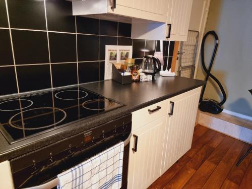 a kitchen with a black counter top and a stove at Kjellerleilighet egen inngang. in Stange