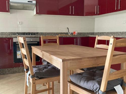 a kitchen with a wooden table and chairs at Superb flat near the Medina in Tangier