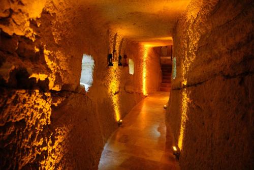 a tunnel in a cave with lights on it at Cappadocia Nar Cave House & Swimming Pool in Nevsehir