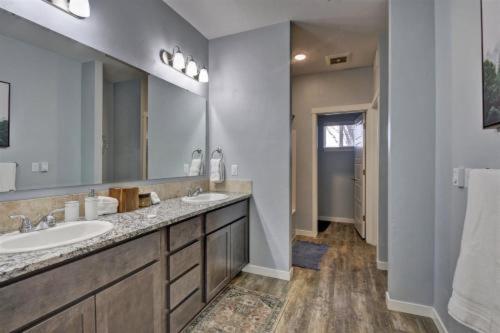 a bathroom with two sinks and a large mirror at 5787 Coffey Villa Perfect for Traveling Professional in Garden City