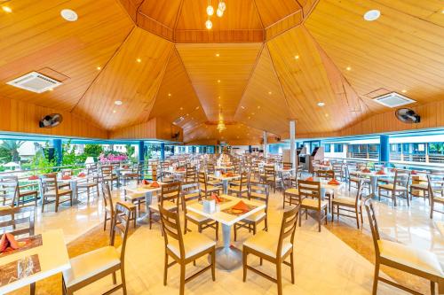 a dining room with tables and chairs in it at Queen's Park Le Jardin in Kemer