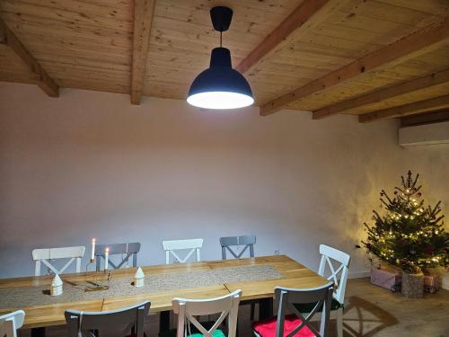 a dining room with a table and chairs and a christmas tree at Casa Mara Viseu de Sus in Vişeu de Sus