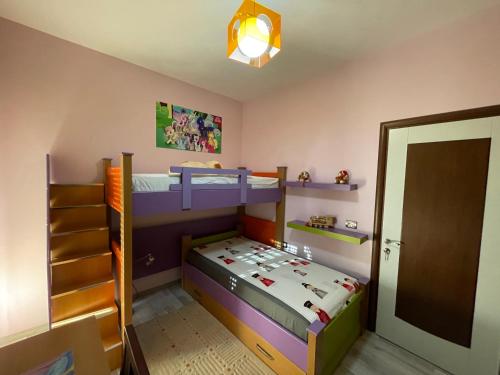 a bedroom with two bunk beds and a staircase at Downtown Apartment in Korçë