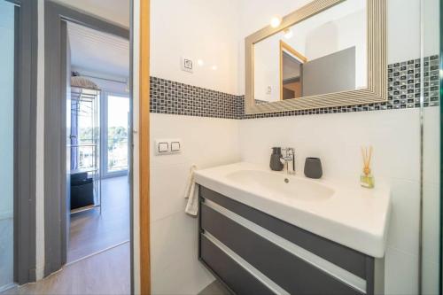 ein Bad mit einem Waschbecken und einem Spiegel in der Unterkunft La Maison Snoopy, 6-8 persons, near beach, seaview in Lloret de Mar