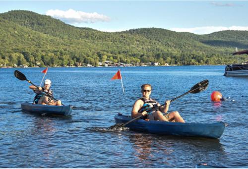 two people are in kayaks on a lake at Waters Edge Lodge in Lake George