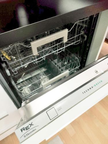 a dishwasher with its door open on top of it at B&B Vimo - Appartamento con terrazzo privato Milano San Raffaele - Vimodrone in Vimodrone