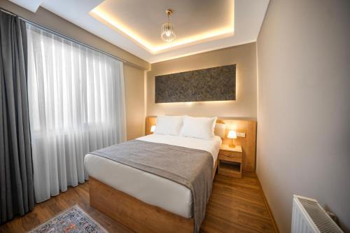 a hotel room with a bed and a window at StayHub in Istanbul