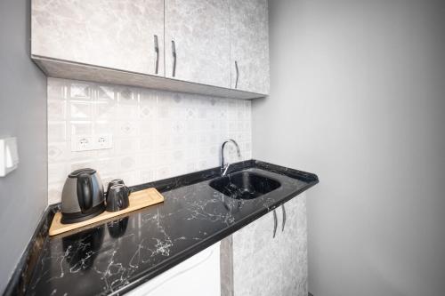 a kitchen with a black counter top with a sink at StayHub in Istanbul