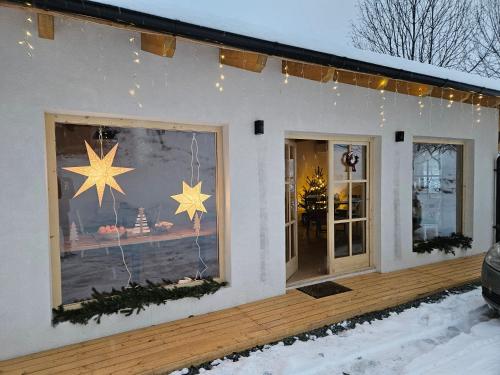 a house with christmas lights in the window at Casa Mara Viseu de Sus in Vişeu de Sus