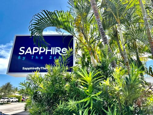 a sign for sapphire by the sea with palm trees at Sapphire by the Sea in Fort Lauderdale
