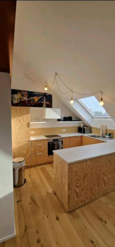 a large kitchen with a ceiling with a skylight at Penthouse lumineux in Brussels