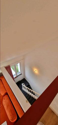 an attic room with a staircase in a house at Penthouse lumineux in Brussels