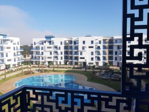 a view from a window of a building with a swimming pool at Appartement de Luxe MARTIL COSTA MAR Pour Familles in Martil