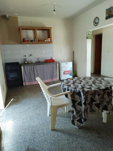 a kitchen with a table and chairs in a room at Casa el Bahual in Tinogasta