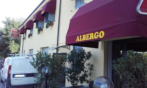 a purple awning with a albergo sign on a building at HOTEL DED 1 CHECKIN a RICHIESTA in Parma