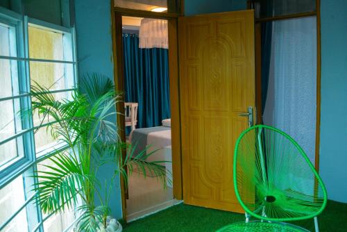 a room with a door and a green fan at The Hidden gem Near Acacia Mall, 2 BDRs in Kampala