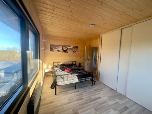 une chambre avec un lit dans une pièce avec une fenêtre dans l'établissement Maison Disneyland Paris, à Chalifert