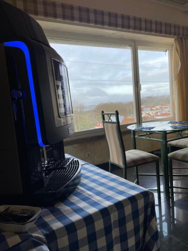 a computer monitor sitting on a table in front of a window at Soltejo in Vila Nova da Barquinha