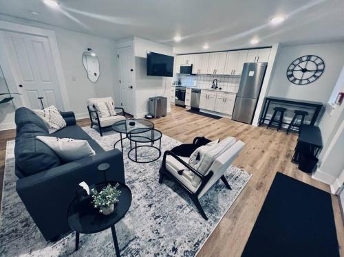 a living room with a couch and chairs and a kitchen at Urban Oasis, OTR Near Casino & Downtown! - 2 beds in Cincinnati