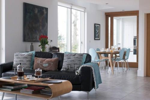 a living room with a couch and a table at Barn Lane @ Drumagosker Rural Retreats in Ardmore
