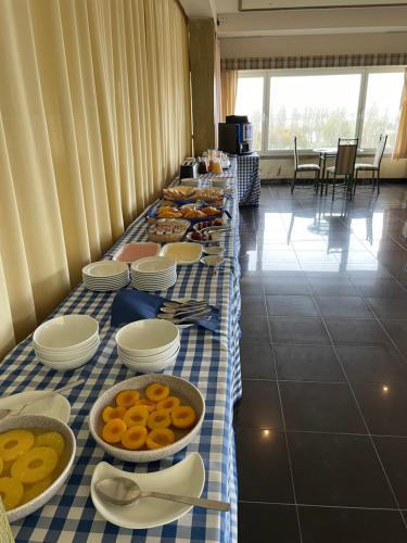 a long table with plates of food on it at Soltejo in Vila Nova da Barquinha