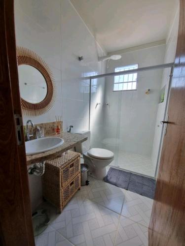a bathroom with a toilet and a sink and a shower at Casa do Renato in Anchieta