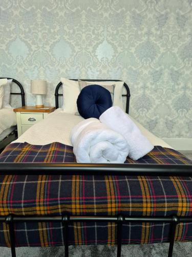 a bedroom with a bed with towels on it at Love Lane Villa in Lincoln