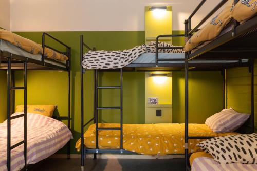 a room with three bunk beds in a room at Hostel Ani&Haakien in Rotterdam
