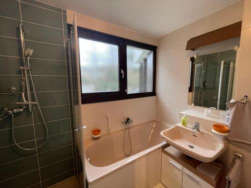 a bathroom with a tub and a sink and a shower at Fewo Steuer in Traben-Trarbach