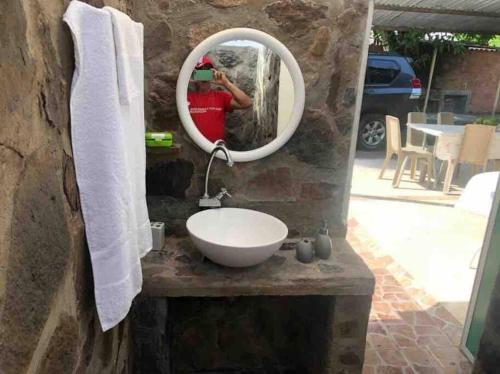 a person taking a picture of a sink in a mirror at Fresca casa completa Monterrey casanare in Monterrey
