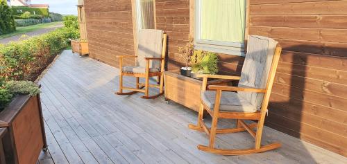 two chairs sitting on the porch of a house at Entire Home - Unique Quiet Quality Near the Sea in Horten