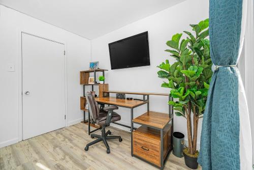 an office with a desk and a tv on a wall at Oceanfront Jewel - Remodeled to Perfection in Rehoboth Beach