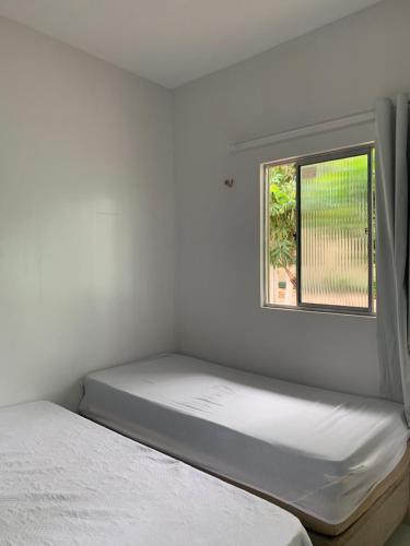 Una cama o camas en una habitación de Happy Hostel e Pousada Paracuru