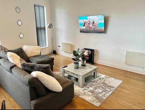 a living room with a couch and a table at Home In The Heart Of Southsea in Portsmouth