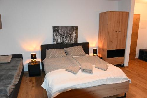 a bedroom with a large bed with two pillows at Nicky apartments and studios in Niederau
