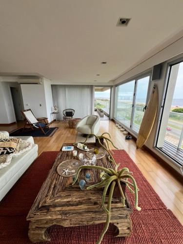 a living room with a table in the middle of it at Penthouse Villa brava in Punta del Este