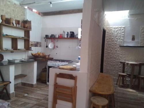 a small kitchen with a stove and a counter at Casa Wilson in Morro de São Paulo