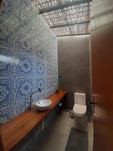a bathroom with a sink and a toilet at Loft Enseada in Guarujá