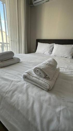 Postel nebo postele na pokoji v ubytování Tinyhug Apartment