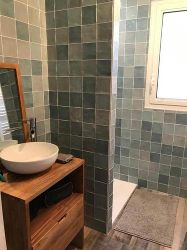 une salle de bain avec un lavabo et un miroir dans l'établissement Maison sur la côte des légendes 4P, à Porspoder