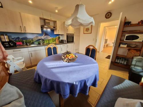 a kitchen with a table with a bowl of fruit on it at Ferienwohnung Freymiller in Bad Kohlgrub