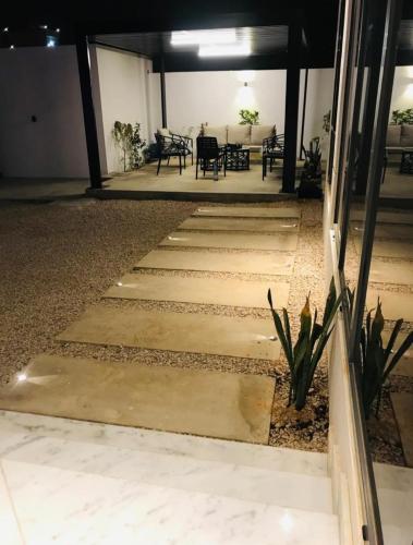 a set of stairs leading to a room with a table at VALLEY in Sikun Shikfainot