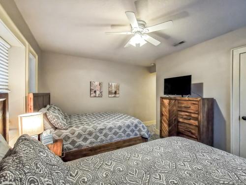 a bedroom with two beds and a flat screen tv at Large Plaza 2BR BTH in Kansas City