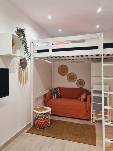 un salon avec un lit superposé et un canapé dans l'établissement Studio cosy à Stains proche Paris-Stade de France, à Stains