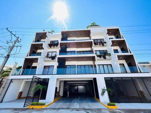 a large white building with a lot of windows at Antara Moderno condominio in Mazatlán