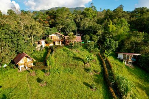 an aerial view of a house on a hill at El Refugio del Oso de Anteojos in Fómeque