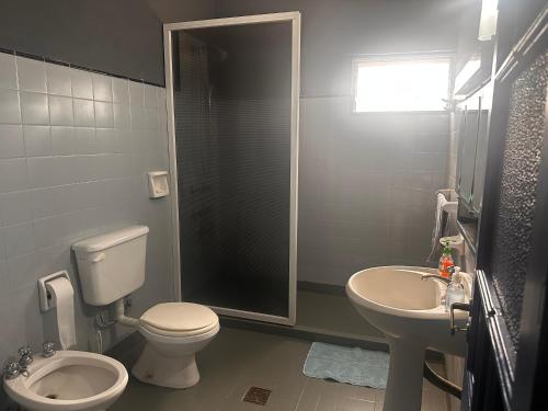 a bathroom with a toilet and a sink at Quinta Mitre in San Nicolás de los Arroyos